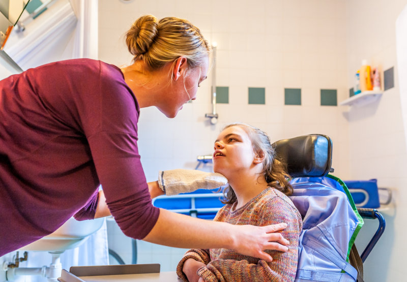 child with special needs in a wheelchair being cared for by a special needs nurse