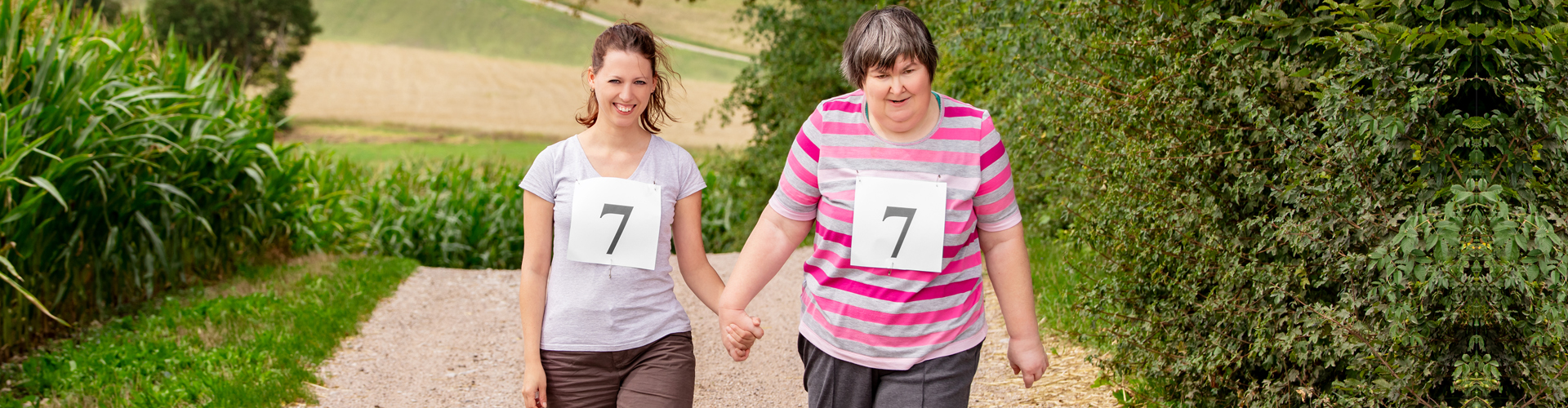 woman and a middle aged woman walking and has a number