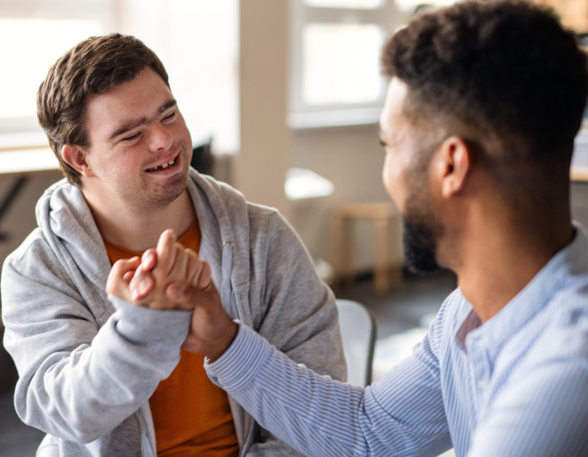 two man smilling while holding hands