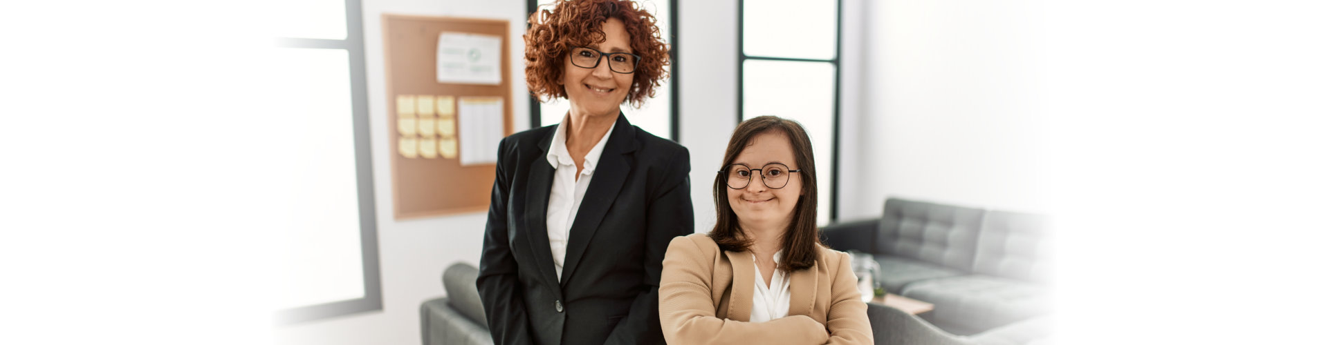 two woman in formal attire smilling