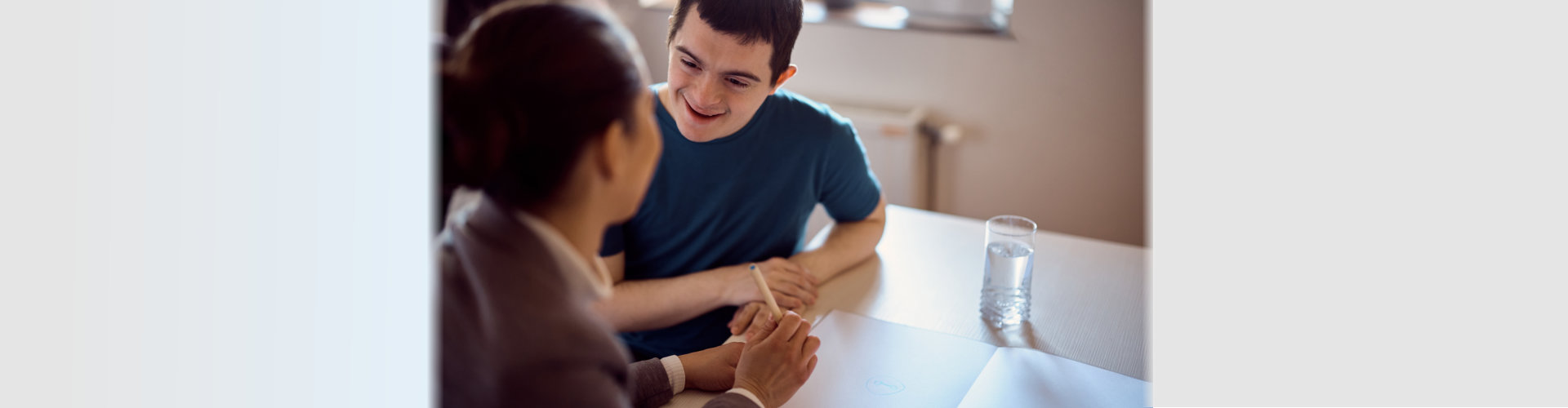 image of a man with special needs and a woman talking